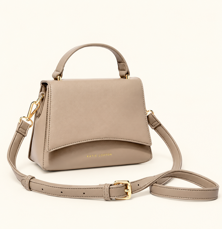 Katie Loxton Rae Crossbody Bag in Soft Tan with top handle, adjustable crossbody strap, curved flap, and gold-tone hardware.