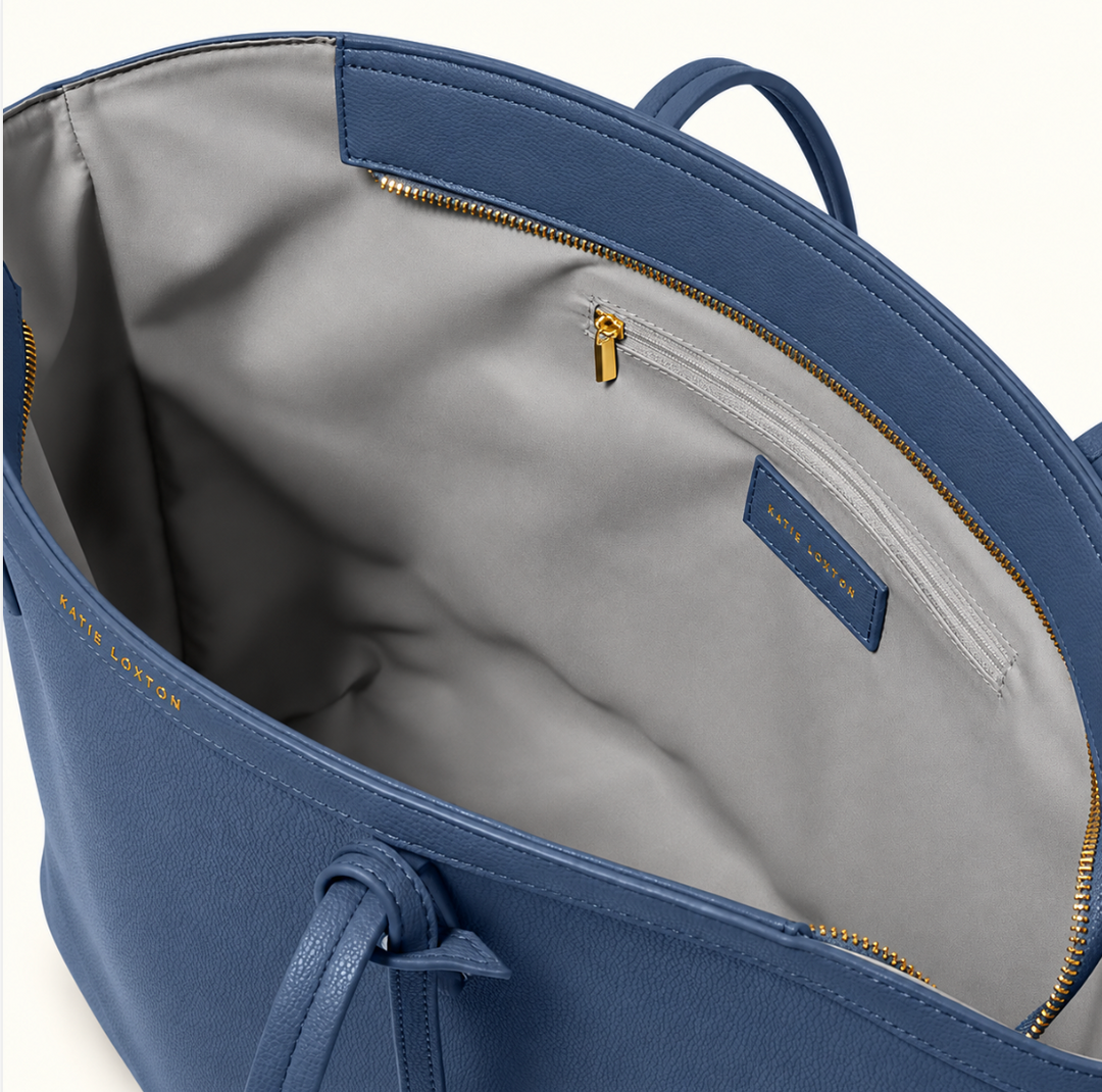 Interior view of Katie Loxton Travel Tote in Navy showing spacious RPET lining, secure zip-top closure, and interior zippered pocket.