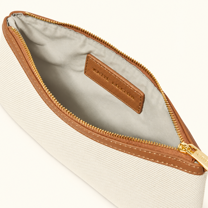 Interior view of Katie Loxton Capri Canvas Pouch in tan and off white with gold zipper and lined interior