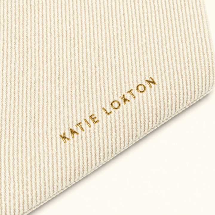 Close-up of Katie Loxton Capri Canvas Pouch in off white textured canvas with gold Katie Loxton logo