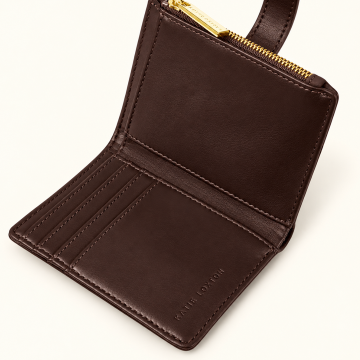 Interior of Katie Loxton Orin Twist Lock Purse in Bitter Chocolate showing card slots, zip compartment and brown lining