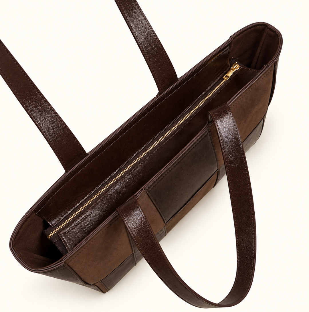 Top interior view of Katie Loxton Taya Woven Tote Bag in Bitter Chocolate showing spacious design, long shoulder straps and gold-tone zip compartment