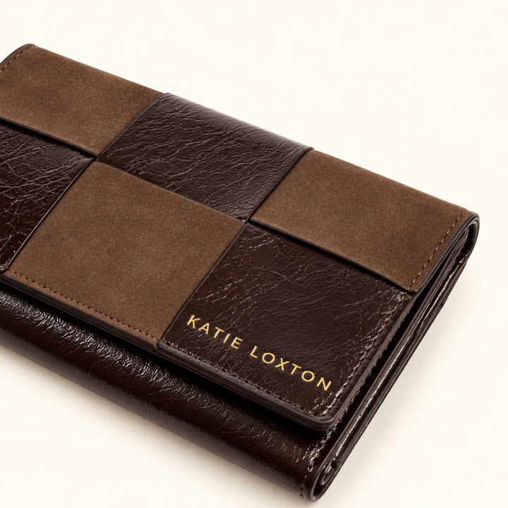 Close-up of Katie Loxton Taya Woven Purse in Bitter Chocolate showing suedette, patent crackle panels and gold logo