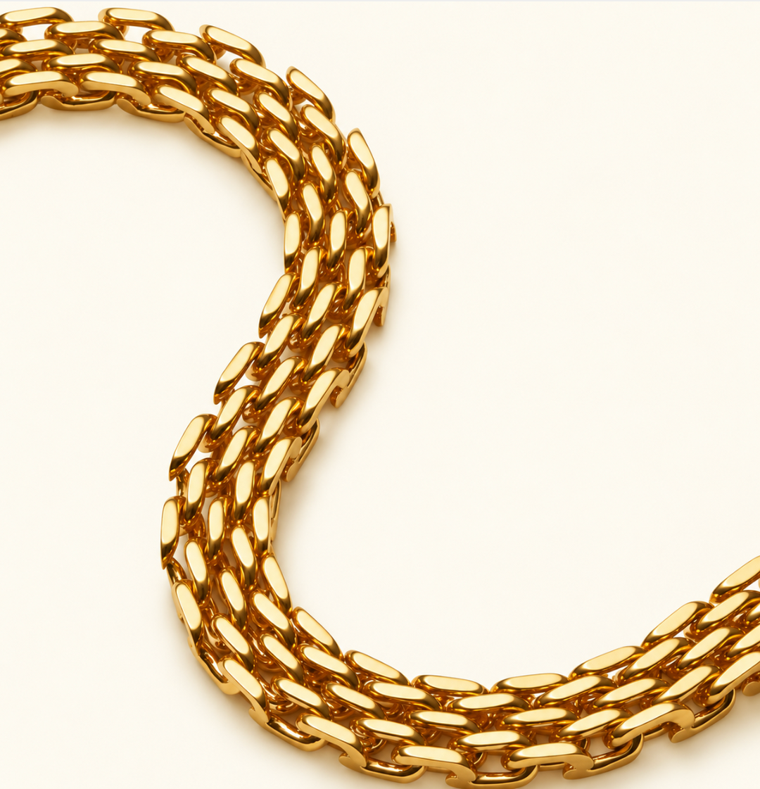 Close-up of Katie Loxton gold Braid Chain Bracelet showing polished 18K gold PVD coated interwoven chain links