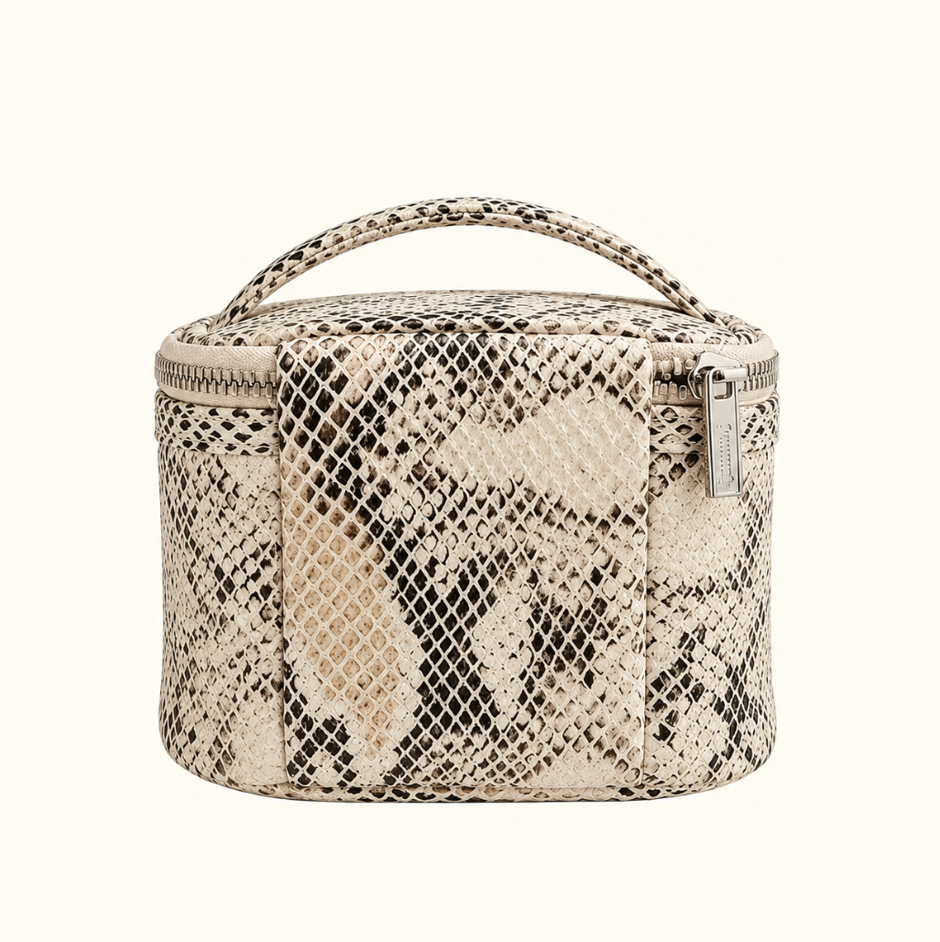 Safari Sands cream python print jewelry travel case featuring a matching carrying handle, silver zipper closure, and exterior storage panel against a cream studio background.