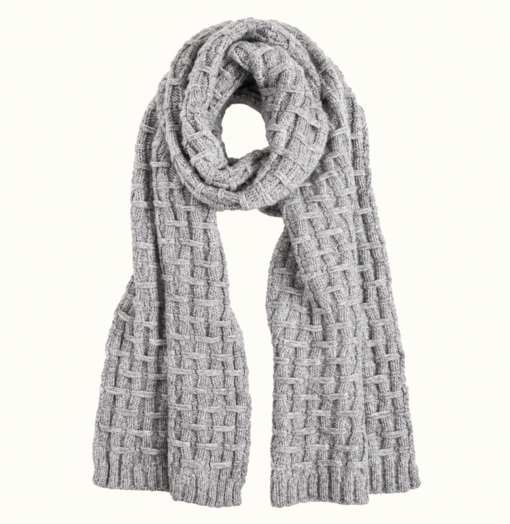 CoCo + Carmen women's chunky knit winter scarf in heather grey featuring a textured basket-weave pattern, thick cozy knit, and ribbed ends, styled in a loop on a cream studio background.