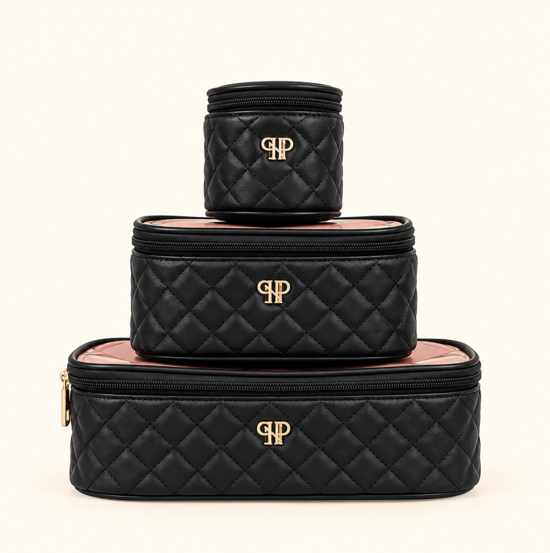 Three black quilted cosmetic organizer bags in small, medium, and large sizes, featuring gold monogram accents and zippered closures, stacked together on a cream background.