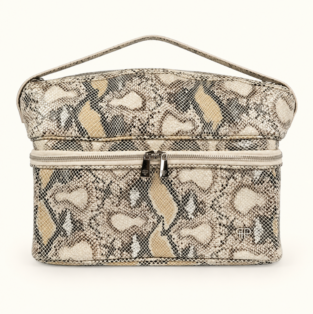 Stylist Travel Bag in Safari Sands cream python print featuring a heat-resistant top compartment, double zippered storage, and carrying handle on a cream background.