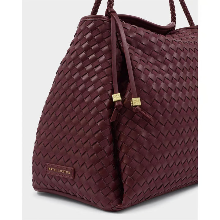Close-up of Katie Loxton Nova Large Shoulder Bag in Cherry Mixed showing hand-woven texture, gold-tone details and branded side accent.