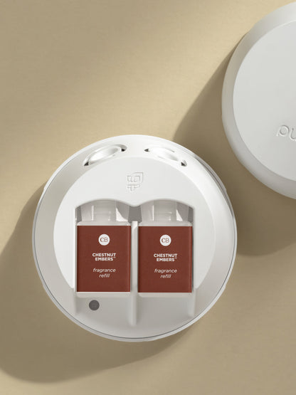 Pura smart home fragrance diffuser loaded with dual Capri Blue Chestnut Embers refills