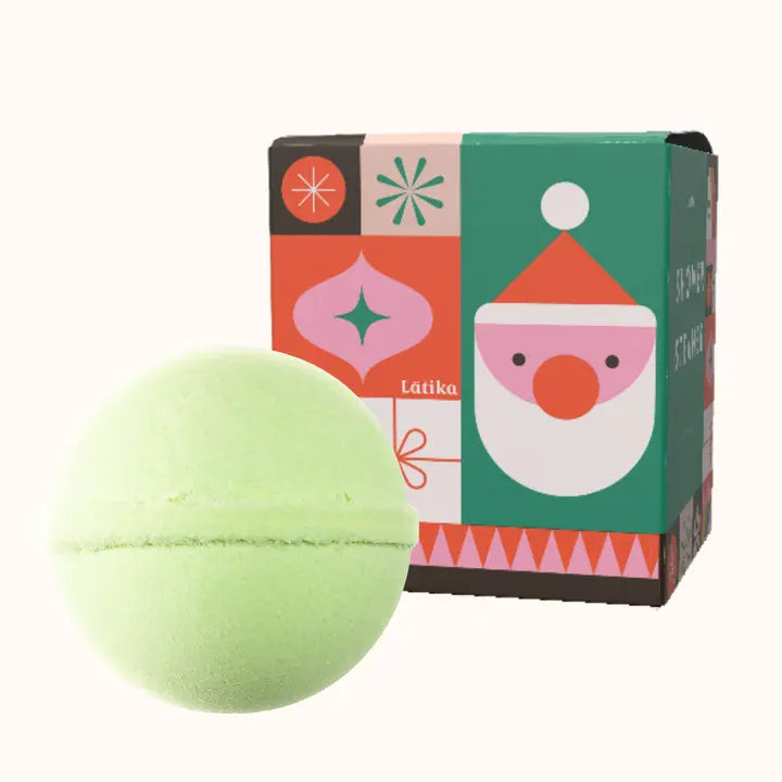Green bath bomb with a colorful box featuring a Santa Claus face on a white background